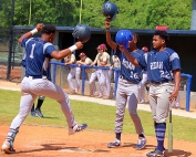 Redan second baseman Bernard Moon (1) celebrates the first of his three home runs on the night with teammates Daelyn House (16) and Manolo Parcel (22). Moon had a two-run homer in each of the first and second innings of the opener, added a solo shot in the second game and had six RBIs on the night in the playoff sweep of Dawson County. (Photo by Mark Brock)