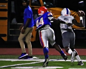 Colulmbia defender Arlando George (44) chases Washington quarterback Tyrek Woods out of bounds. (Photo by Mark Brock)