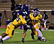 Southwest DeKalb's Isaiah Scott (25) and Wesley Brown (11) get pressure on Redan quarterback Daemon Jones during the Panthers' 55-6 win in the long-running rivalry. (Photo by Mark Brock)