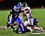 Stephenson's Markel Key (2) and teammate Delali Flowers (1) teammate up to bring down Westminster running back Wade Penn (31).