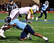 Cedar Grove's Quinterio Lawson (2) brings down the Calvary Day quarterback for a loss in the Saints win last Friday. (Photo by Mark Brock)