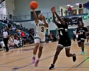 Arabia Mountain's Jayla Thomas (3) goes in for a layup on a fastbreak against Martin Luther King's Amelia Stewart (4) during Arabia's 91-11 win. (Photo by Mark Brock)