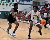 Martin Luther King's RJ Norwood (left) defends against Arabia Mountain's Korey Gribble (11) during Arabia Mountain's 62-54 win on Friday night. (Photo by Mark Brock)