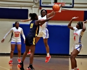 Columbia's Kerselin Anderson (1) and Kamri Gilbert (4) close in on a double team of Eagle's Landing Christian's Madison Norwood (21) during Columbia's 57-16 win over the Chargers. (Photo by Mark Brock)