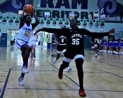 Chamblee's Chris Garrett (12) lifts off toward the basket against Arabia Mountian's Traevon Williams (35) during second halff action last week. (Photo by Mark Brock)