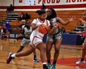 Stone Mountain's Nyla Warren (33) drives inside against Hapeville's Ava Freeman (23) during Stone Mountain's Region 6-4A loss to Hapeville. (Photo by Mark Brock)