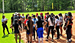 Gary Anderson (in hat) gives instructions to DeKalb Softball Clinic attendees at Cofer Park. (Photo by David Hill)