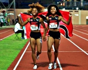 Druid Hills 2024 grads Sole (left) and Sanaa Frederick (right) sport the country of Trinidad and Tobago flag after earning a trip to the 2024 Summer Olympic Games in Paris beginning on July 26. The pair are part of the 4x100-meter relay team headed to Paris. (Courtesy Photo)
