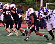 Druid Hills' running back Zach Manning (with ball) in action earlier this season against Miller Grove ran for 210 yards, two touchdowns and a two point conversion to lead the Red Devils to a 28-13 win over North Springs. (Photo by Mark Brock)