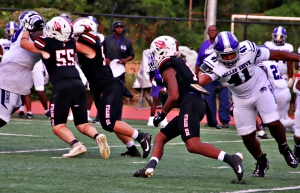 Druid Hills' running back Zach Manning (with ball) in action earlier this season against Miller Grove ran for 210 yards, two touchdowns and a two point conversion to lead the Red Devils to a 28-13 win over North Springs. (Photo by Mark Brock)