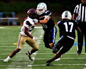 Chamblee's Edward Reed (17) cuts behind the block of lineman William Tate (56) against Tucker's Izaiah Williams (22) for a short gain. Photo by Mark Brock)