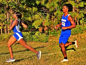 Stephenson's Breona Issac (left) and Gene Jones gave the Jaguars a strong finish in the final regular season cross country meet in DeKalb. Jones took first in the boys' race and Issac was second in the girls' just .40 behind Stone Mountain's Shekinah Williams who took medalist honors. (Photos by Henrietta George)