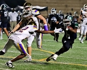 Arabia Mountain's Jordan Walker (6) avoids a pair of Viking defenders on his way to a receiving touchdown. He also had a 92-yard kickoff return in the tough 51-50 loss. (Photo by Mark Brock)