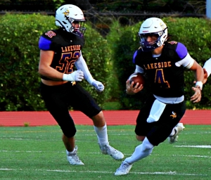 Lakeside quarterback Kyle Davis (4) runs past lineman William Maugnon (52) in action against Berkmar last season. Davis led the Vikings to a 25-21 come-from-behind win over Macon County with a QB sneak in the fourth quarter. (Photo by Mark Brock)