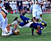 Southwest DeKalb's Joshua Jones (0) dives over a St. Pius defender into the end zone for an early touchdown of the Panthers' tough 28-27 loss to the Golden Lions on Thursday. (Photo by Mark Brock)