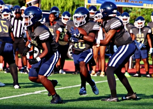 Southwest DeKalb's Tamir Rudolph (7) lead blocks for Joshua Jones (10) as he takes a handoff from quarterback Braylon Carter (2) during preseason action against Columbia. (Photo by Mark Brock)