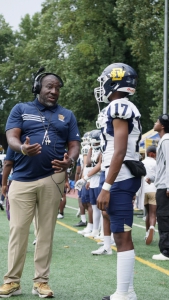 Southwest DeKalb Coach Marion Bell talks with backup QB Tommie Traylor who threw for one of the seven passing touchdowns by the Panthers in a 61-7 win over the Chamblee Bulldogs. (Photo by Christian Orozco Morales)