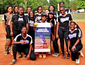 The Miller Grove Wolverine softball team celebrated teammate Amiyah Morrison's school record for strikeouts before their win over Columbia on Tuesday night. (Photo by Mark Brock)