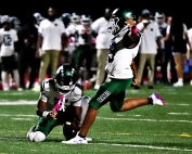 Arabia Mountain's Jayden Thomas holds for an extra point by teammate Mohan Masih as the Rams grabbed a halftime lead in the loss to Dunwoody. (Photo by Mark Brock)