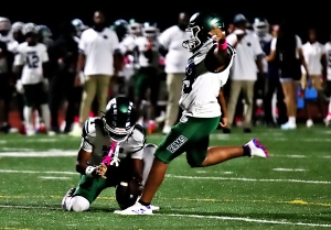 Arabia Mountain's Jayden Thomas holds for an extra point by teammate Mohan Masih as the Rams grabbed a halftime lead in the loss to Dunwoody. (Photo by Mark Brock)