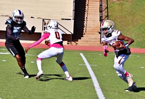 Champion quarterback Marcus Green (13) scrambles as teammate Tyson Zellars (0) blocks Cedar Grove defender Landon Carnahan (91) during the hard fought battle in the first round of the Trail to the Title playoffs. (Photo by Mark Brock)