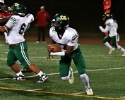 Cross Keys quarterback Christian Holmes looks for running room against the Stone Mountain Pirates. (Photo by Mark Brock)