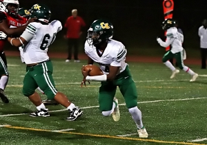 Cross Keys quarterback Christian Holmes looks for running room against the Stone Mountain Pirates. (Photo by Mark Brock)