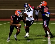 Columbia quarterbac Cameron Graves (1) scrambles away from the pressure put on by Miller Grove's Mrlon McClean (41) as teammate Antonio Wihiters (55) tries to block the Wolverine. (Photo by Mark Brock)