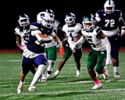 Dunwoody's Cameron Irastorza (left) runs for a big gain as Arabia Mountain's Jaden Sancho (5) gives chase. Irastorza had a rushing and receiving touchdown in Dunwoody's 28-19 win. (Photo by Mark Brock)