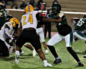 Lithonia running back ALbert Gooding (20) cuts away from Clarkston defender Kaedon Ferris (22) for nice gain. Gooding finished with 112 yards rushing and two touchdowns in the 54-0 Lithonia win. (Photo by Mark Brock)