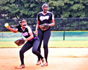 Miller Grove shortstop Mariah Presley (left) comes up throwing on an infield grounder as second baseman JaNiya Smith backs up on the play. The Wolverines lost their first game of the Class 2A double elimination tournament in Columbus. (Photo by Mark Brock)