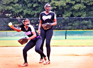 Miller Grove shortstop Mariah Presley (left) comes up throwing on an infield grounder as second baseman JaNiya Smith backs up on the play. The Wolverines lost their first game of the Class 2A double elimination tournament in Columbus. (Photo by Mark Brock)