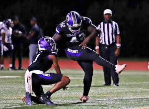 Miller Grove's Ahmed Jatta (42) kicks a PAT out of the hold of Thomas Winston IV (1) in a win over Redan earlier this season. The pair look to teammate several times in their key Region 6-2A match up with South Atlanta tonight (Friday, Oct. 18). (Photo by Mark Brock)