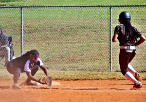 Miller Grove first baseman Saniya Francis (left) makes the play on a low throw to get a Thomson base runner during the Wolverines sweep of the Bulldogs to reach the Class 2A Elite 8 state tournament. Miller Grove plays Stephens County at 11:00 am at the Columbus Softball Complex on Wednesday. (Photo by Mark Brock)