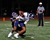 Miller Grove's Dominick Jackson (black jersey) tackles Redan punter Fereud McKnukle at the two-yard line to set up the Wolverine's second touchdown of the second quarter., a two-yard run by Nashuan Porter. Miller Grove tied the series with the Raiders at 3-3-1 with a 41-6 win on Thursday night. (Photo by Mark Brock)