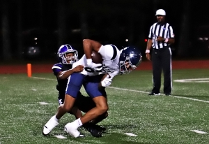 Miller Grove's Dominick Jackson (black jersey) tackles Redan punter Fereud McKnukle at the two-yard line to set up the Wolverine's second touchdown of the second quarter., a two-yard run by Nashuan Porter. Miller Grove tied the series with the Raiders at 3-3-1 with a 41-6 win on Thursday night. (Photo by Mark Brock)