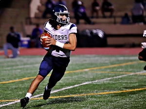 Redan quarterback Dameon Jones rolls to his right looking for a receiver during fourth quarter action in a 41-6 loss to Miller Grove. (Photo by Mark Brock)