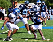 Stephenson linebacker Romando Craddock had a big day against Cedar Grove and running back Zsewaun Smith (1). Craddock had 2 first half diving interceptions to help the Jaguars to a 14-8 halftime led. (Photo by Mark Brock)