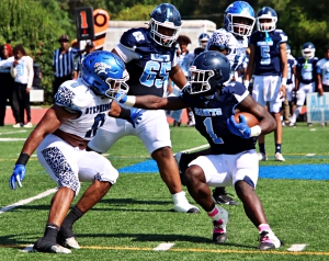 Stephenson linebacker Romando Craddock had a big day against Cedar Grove and running back Zsewaun Smith (1). Craddock had 2 first half diving interceptions to help the Jaguars to a 14-8 halftime led. (Photo by Mark Brock)