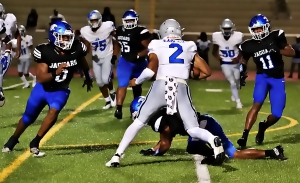 Stephenson middle linebacker Romando Craddock (0) and teammate Altariq Smith (11) corner North Clayton quarterback Justin Murphy (2) for a big loss on third and goal. (Photo by Mark Brock)