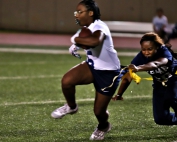 Arabia Mountain's Trinity Rivers (with ball) couldn't quite get away from Redan's Sky Minnifield (pulling flag) during Redan's 42-6 win on Monday. (Photo by Mark Brock)