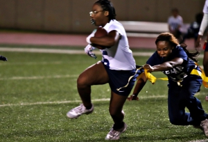 Arabia Mountain's Trinity Rivers (with ball) couldn't quite get away from Redan's Sky Minnifield (pulling flag) during Redan's 42-6 win on Monday. (Photo by Mark Brock)