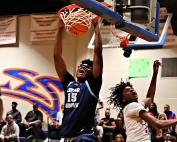 Cedar Grove's Javonte Floyd (15) slams home a the first of four dunks on the night as he combined with Manny Green to lead the Saints to a 61-39 win over the Columbia Eagles. (Photo by Mark Brock)