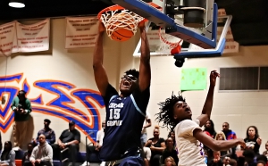 Cedar Grove's Javonte Floyd (15) slams home a the first of four dunks on the night as he combined with Manny Green to lead the Saints to a 61-39 win over the Columbia Eagles. (Photo by Mark Brock)