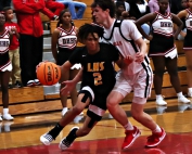 Lithonia's Rayshun Williams (2) drives inside past Druid Hills' Reese Hamburger (11) during the Bulldogs 75-47 Region 5-4A win. (Photo by Mark Brock)