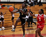 Lithonia's Ja'Miah Dale (with ball) converts a steal into a basket against Druid Hills' Nola Grant (right). (Photo by Mark Brock)