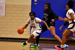 Cedar Grove's Kendedie Blackshear (21) is turned away in front of the basket by Stephenson's Avantey Gilreath (24). Gilreath and her Stephenson teammates picked up a 70-31 Region 5-3A girls' victory at Cedar Grove on Tuesday. (Photo by Mark Brock) 