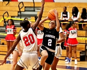 Lakeside's Alani Hill (2) goes up for a layup as Dunwoody's Makayla Tarver (20) defends during first half action of Lakeside's 68-22 road win. (Photo by Mark Brock)