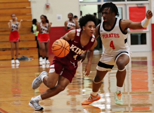 Martin Luther King's Caleb Winfrey (left) gets an opening against Stone Mountain's Vonte Edwards (right) during the Lions road win. (Photo by Mark Brock)