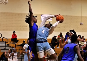 Cedar Grove's Donterious Stringfield Jr. goes up for a layup against Stephenson defenders Michel Gibson during the Saints 79=61 Region 5-3A win at home on Tuesday night. (Photo by Mark Brock)